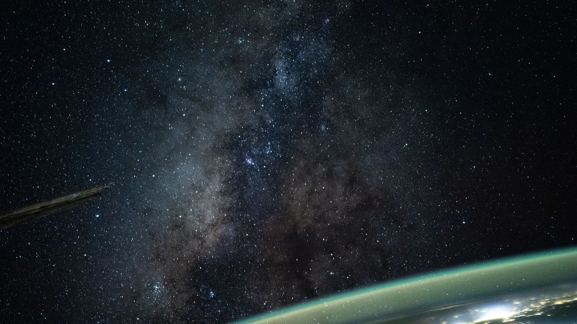 The Milky Way appears above Earth's bright atmospheric glow - free hd space wallpaper for desktop