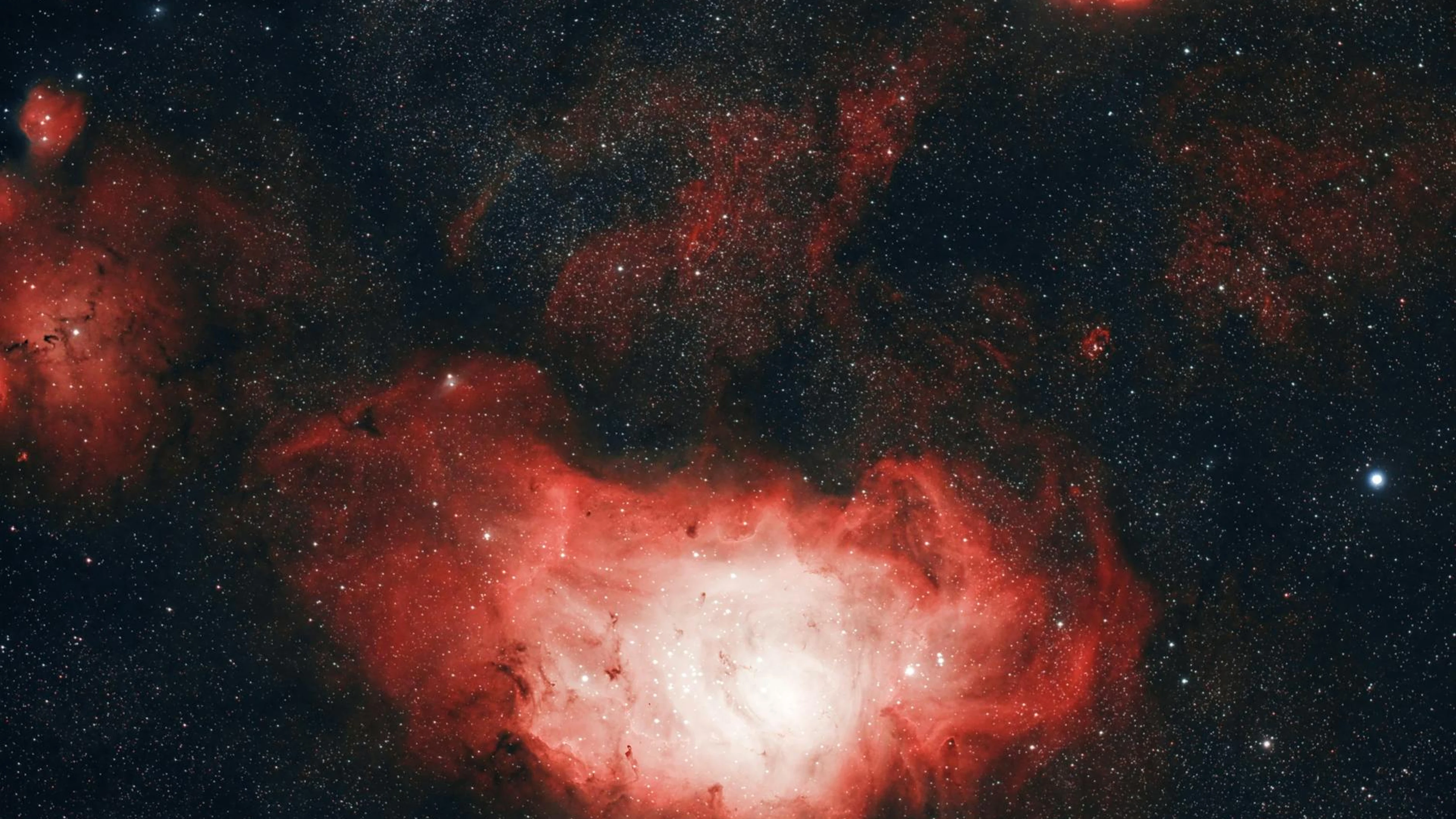 Vivid depiction of the Lagoon Nebula showcasing cosmic beauty and celestial wond - free 4K Ultra HD space wallpaper for desktop