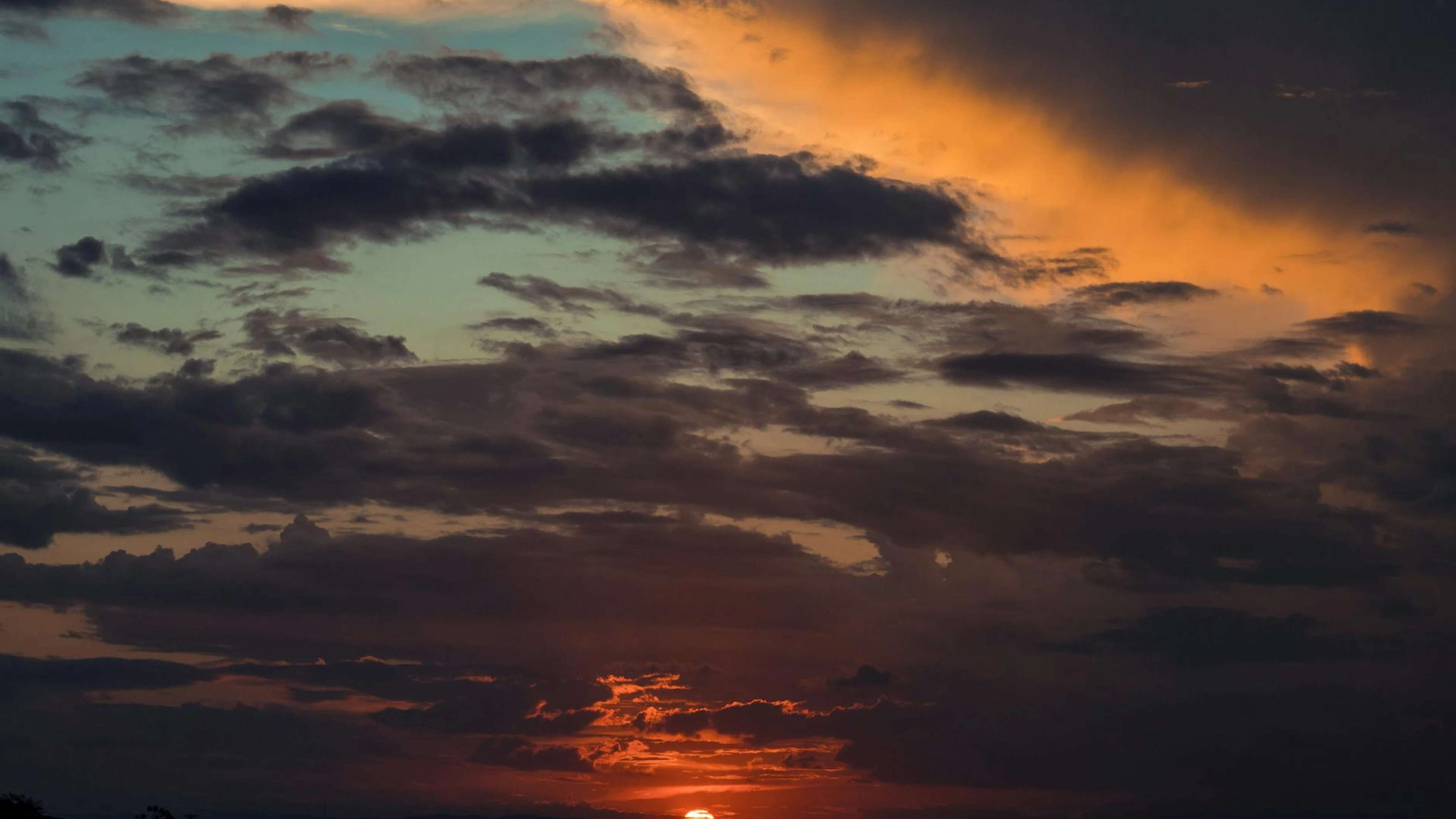 A breathtaking view of the sunset with a dramatic sky and vibrant colors. - free 4K Ultra HD sunset wallpaper for desktop