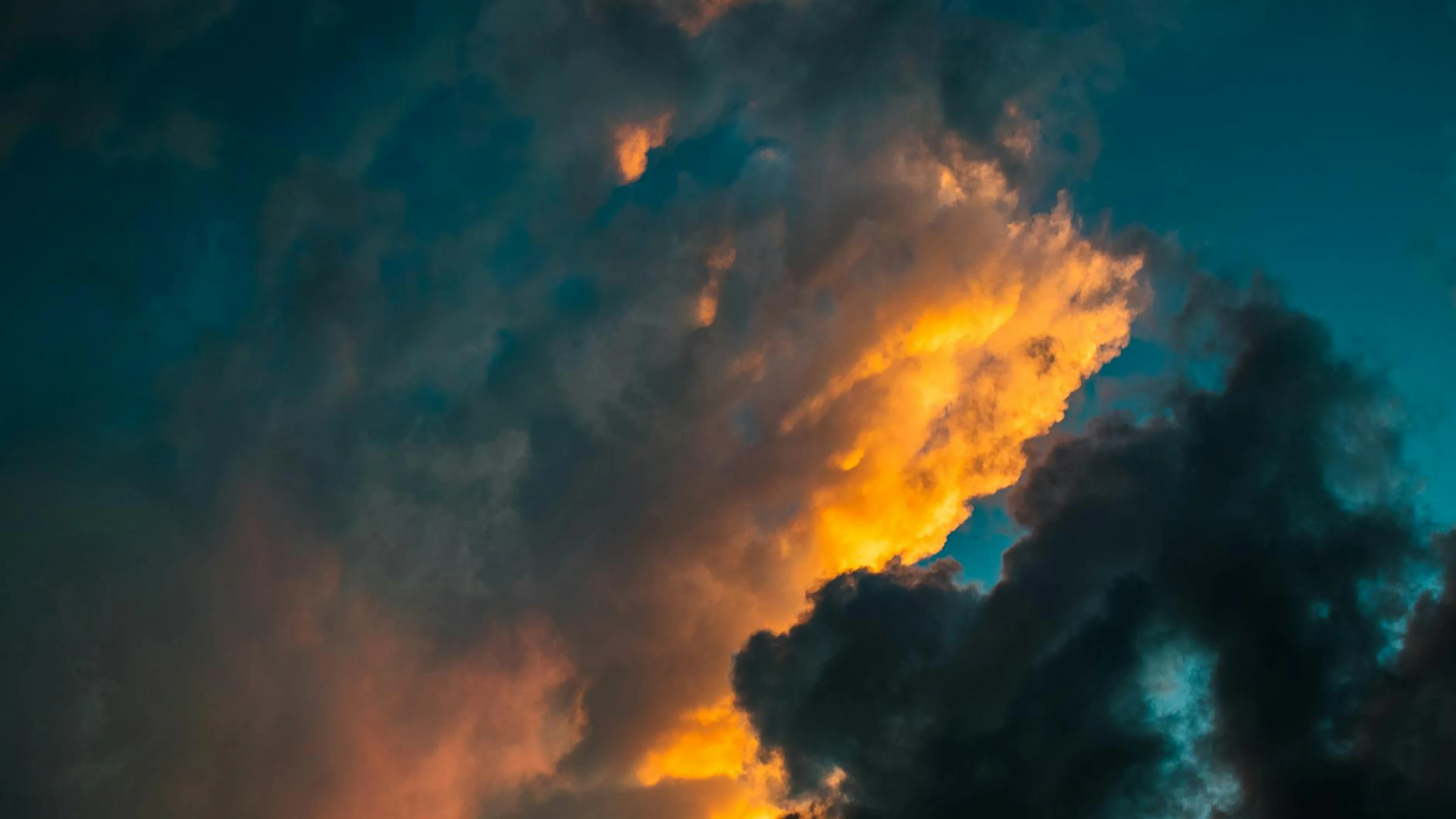 Fiery sunset with vivid clouds creating a dynamic evening sky. - free 4K Ultra HD sunset wallpaper for desktop