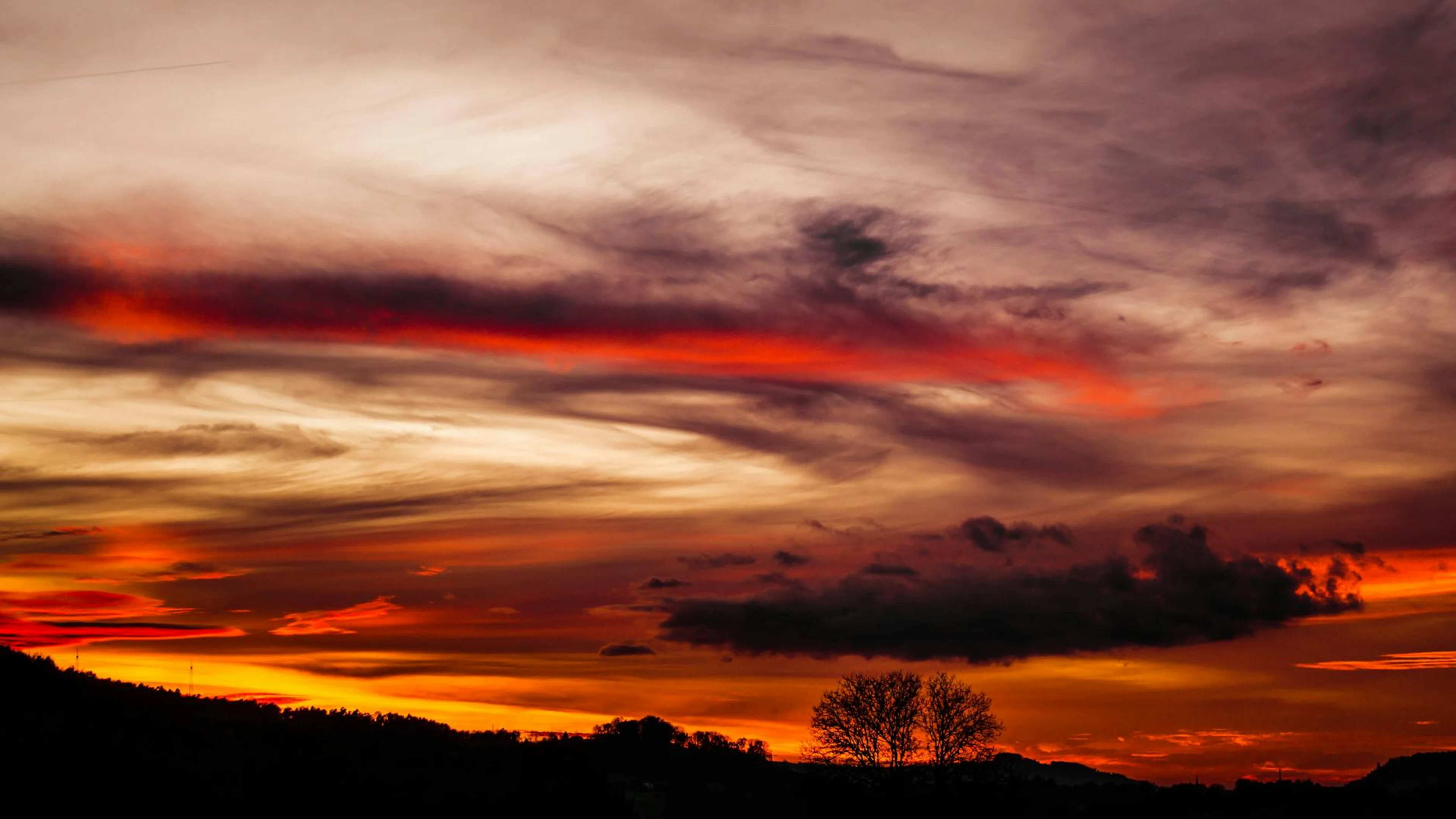 Stunning sunset with dramatic clouds over Plüderhausen, Germany, showcasing vibr - free 4K Ultra HD sunset wallpaper for desktop